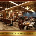 Diners enjoying meals at a popular restaurant on Shimla Mall Road with cozy interiors and mountain views.