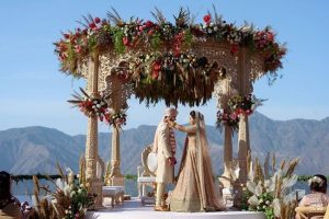 Bride and groom posing against a scenic mountain backdrop during a romantic destination wedding in Shimla.